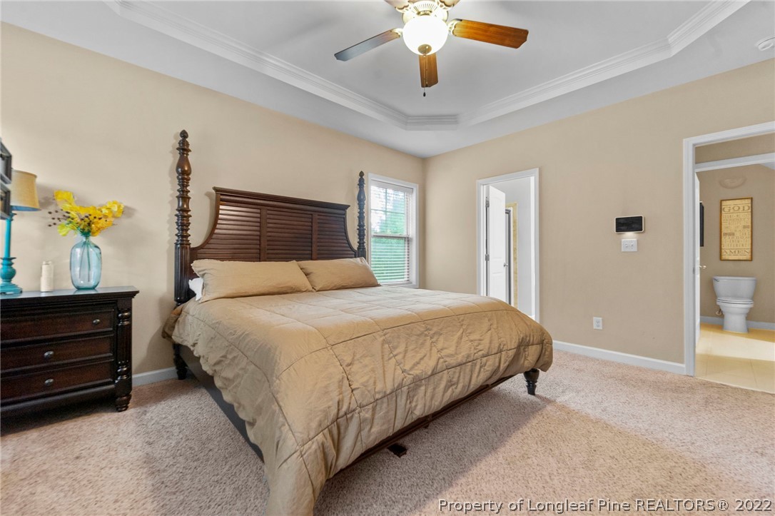 60 Shellbark Drive Spring Lake, NC 28390 - Photo 20 of 42 a bedroom with a bed and a chandelier