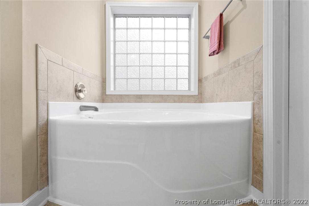 60 Shellbark Drive Spring Lake, NC 28390 - Photo 21 of 42 a bathroom with a bathtub and a window