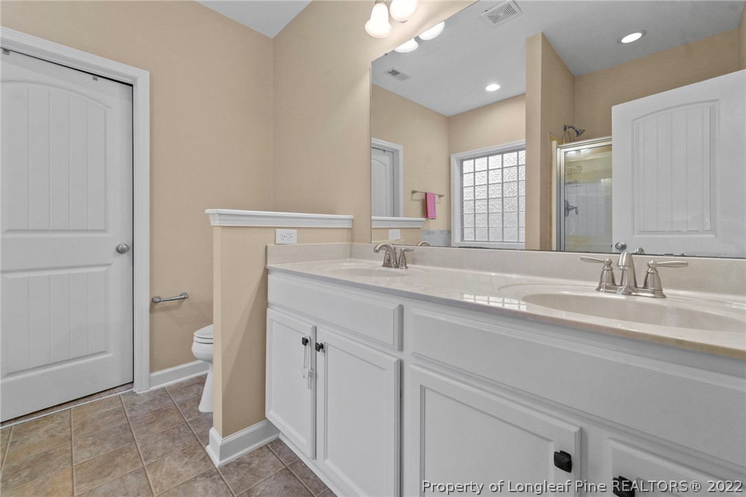 60 Shellbark Drive Spring Lake, NC 28390 - Photo 22 of 42 a bathroom with a double vanity sink and a mirror