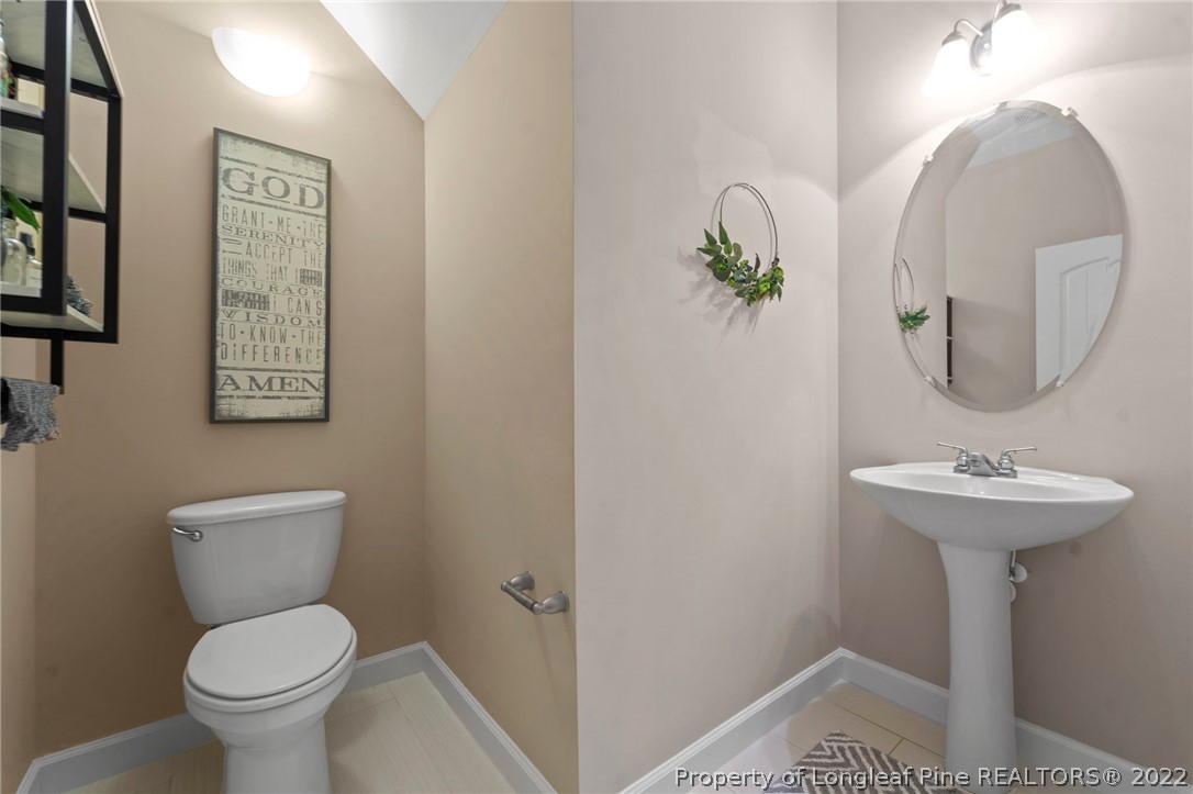 60 Shellbark Drive Spring Lake, NC 28390 - Photo 23 of 42 a bathroom with a toilet sink and mirror