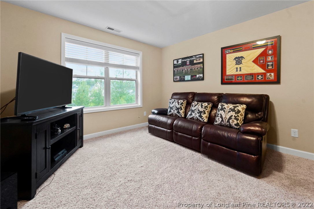 60 Shellbark Drive Spring Lake, NC 28390 - Photo 26 of 42 a living room with furniture and a flat screen tv