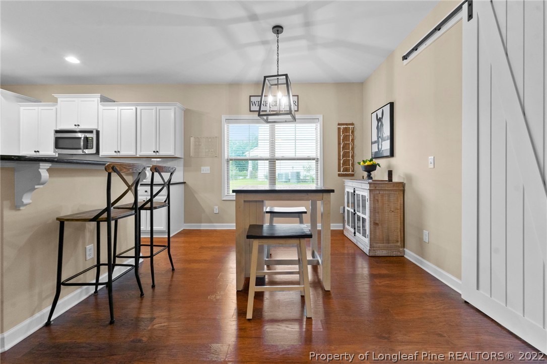 60 Shellbark Drive Spring Lake, NC 28390 - Photo 33 of 42 a view of a dining room with furniture window and wooden floor