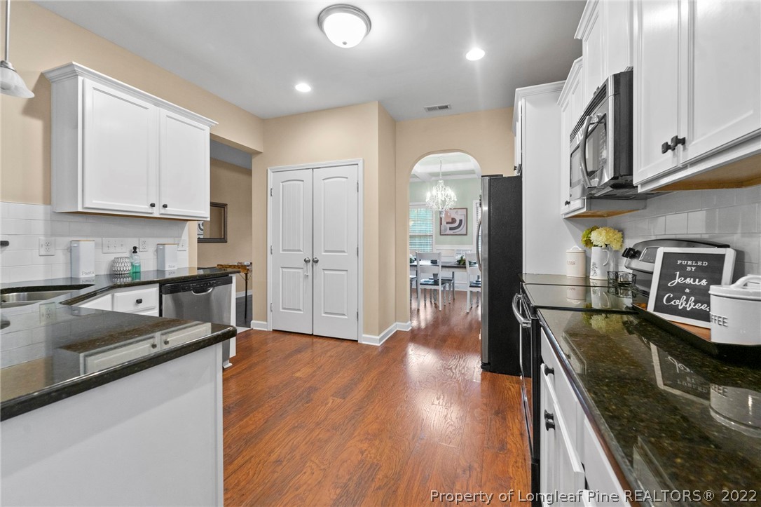 60 Shellbark Drive Spring Lake, NC 28390 - Photo 9 of 42 a kitchen with stainless steel appliances granite countertop a sink stove and refrigerator