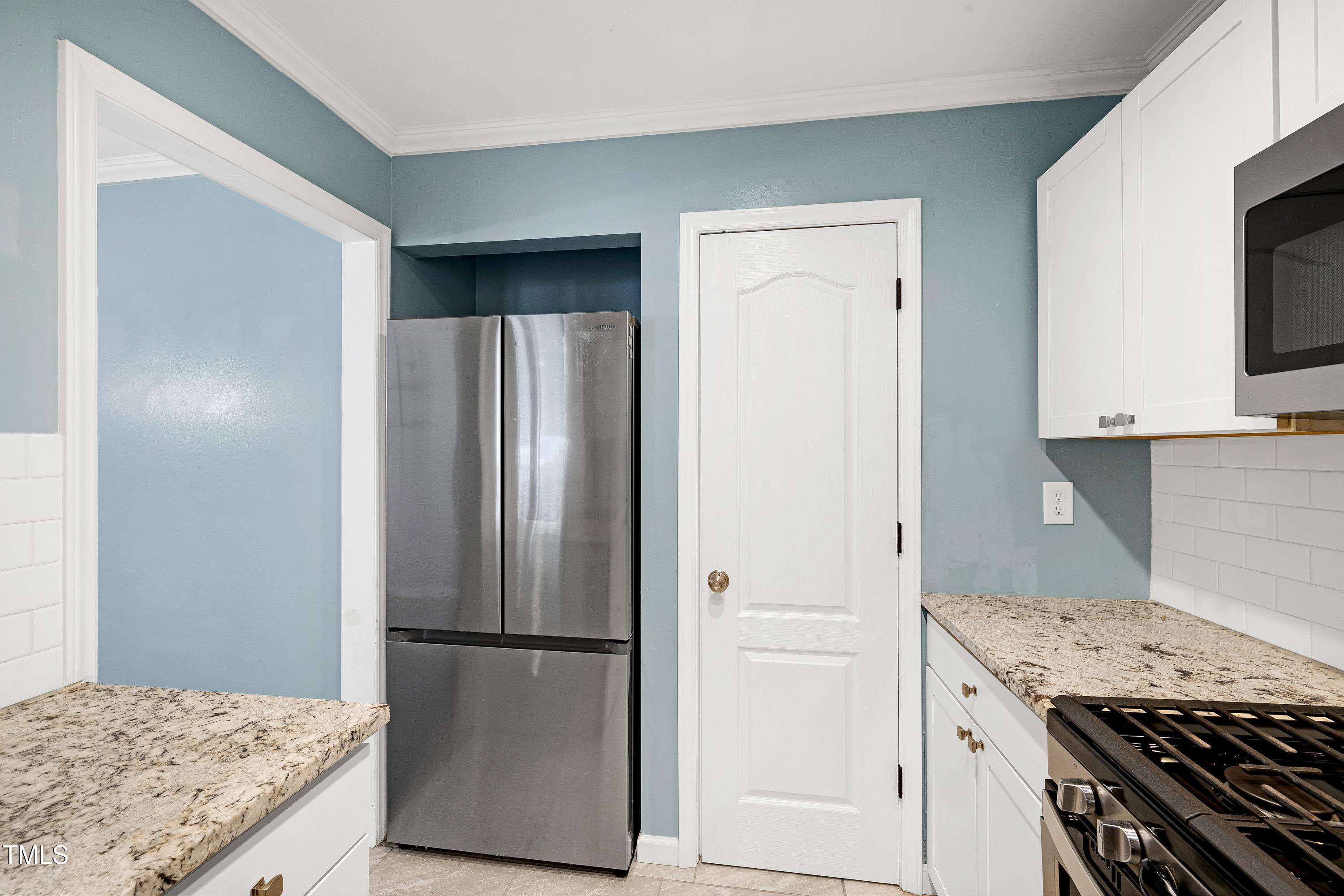 119 Joanne Circle Cary, NC 27513 - Photo 9 of 42 a kitchen with a refrigerator and a stove top oven