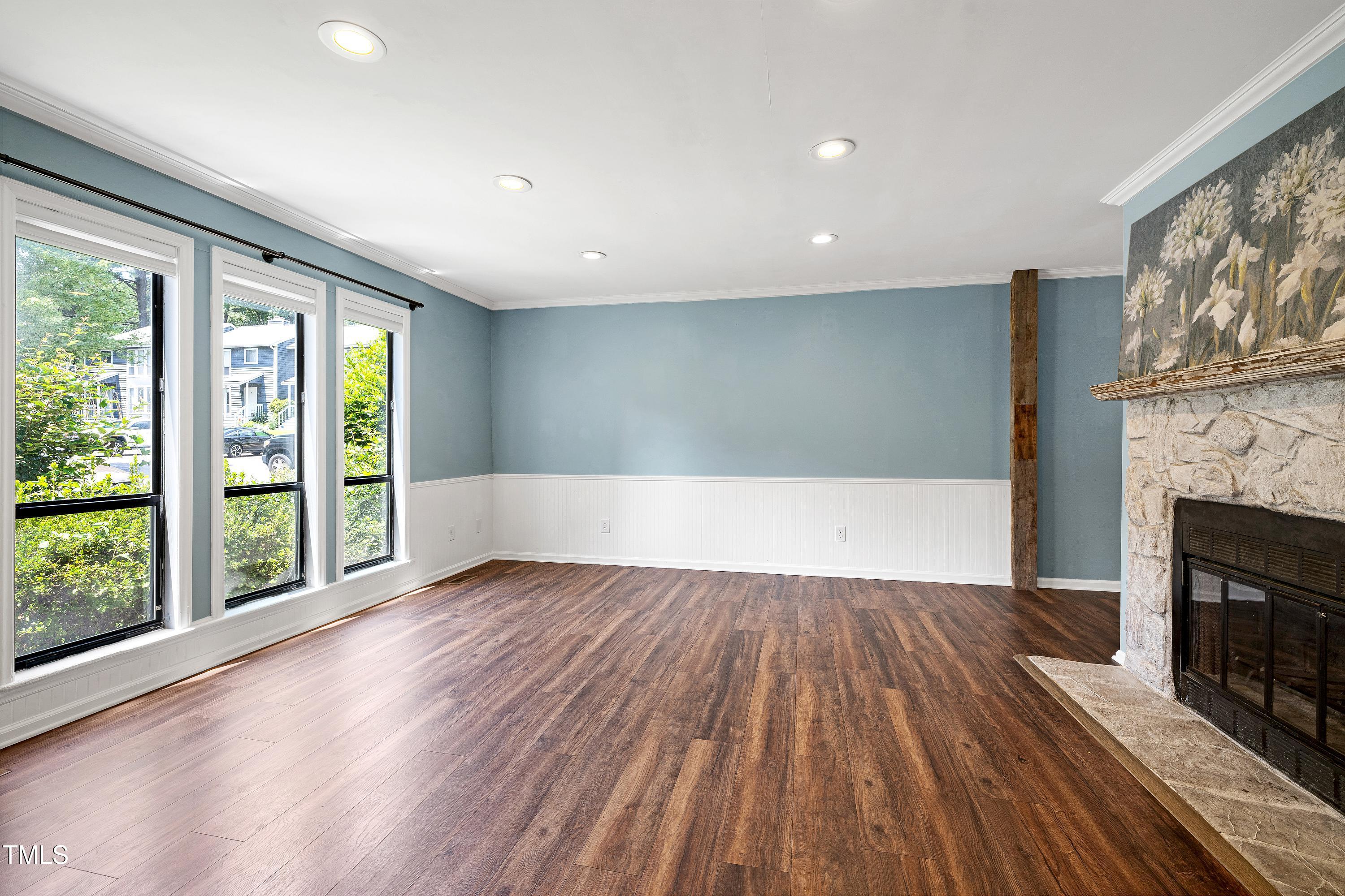 119 Joanne Circle Cary, NC 27513 - Photo 5 of 42 a view of empty room with wooden floor and fireplace