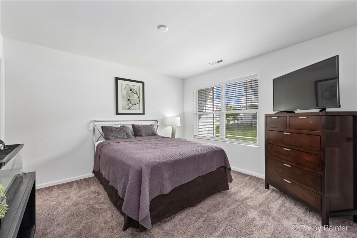 462 Comstock Road South Elgin, IL 60177 - Photo 11 of 23 a bedroom with a bed and a flat screen tv