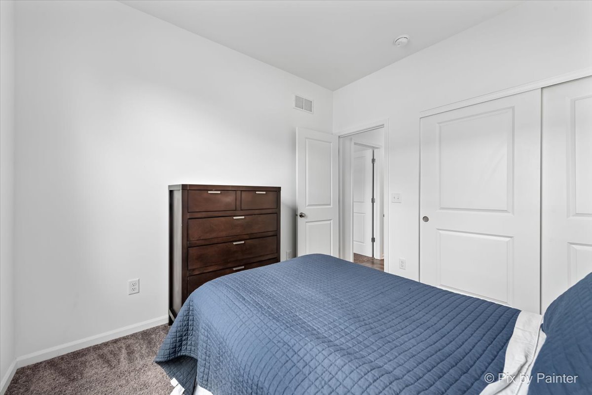 462 Comstock Road South Elgin, IL 60177 - Photo 16 of 23 a bedroom with a bed and a dresser