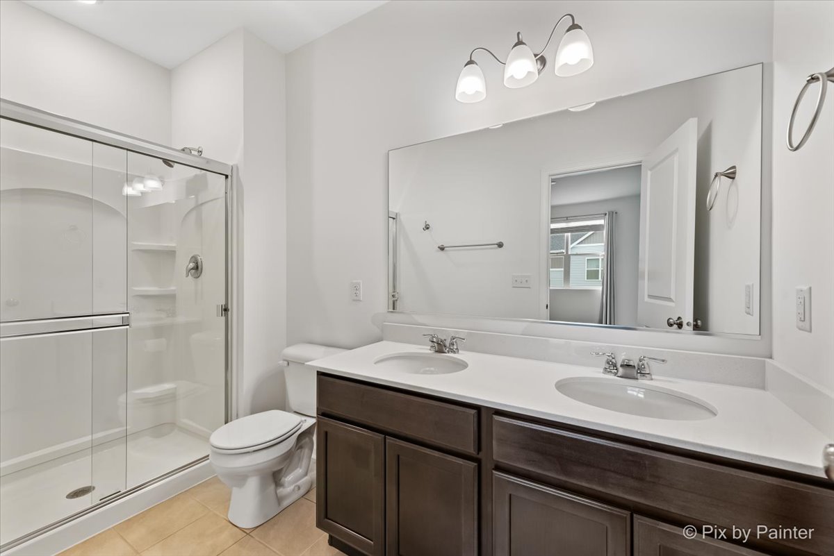 462 Comstock Road South Elgin, IL 60177 - Photo 20 of 23 a bathroom with a sink a toilet a mirror and shower