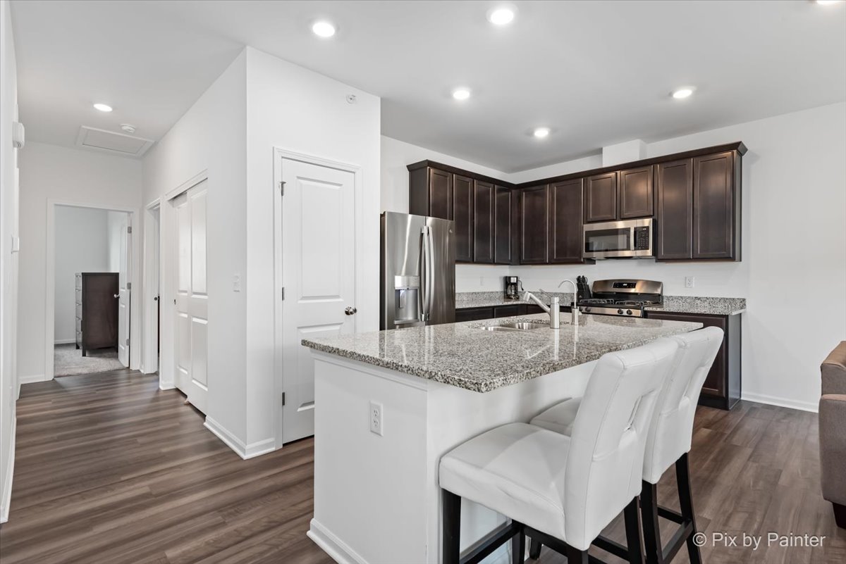 462 Comstock Road South Elgin, IL 60177 - Photo 5 of 23 a kitchen with stainless steel appliances granite countertop a refrigerator stove microwave and cabinets
