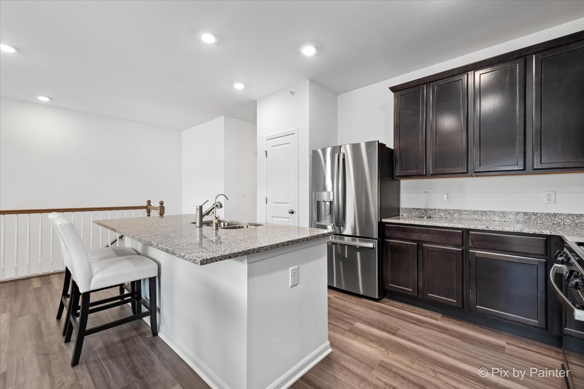 462 Comstock Road South Elgin, IL 60177 - Photo 6 of 23 a kitchen with stainless steel appliances granite countertop a sink stove and refrigerator