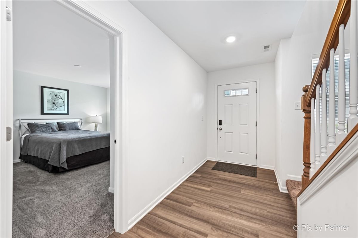 462 Comstock Road South Elgin, IL 60177 - Photo 10 of 23 a spacious bedroom with a bed and a wooden floor