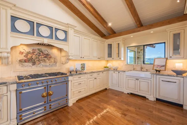 a kitchen with stainless steel appliances granite countertop a stove and cabinets