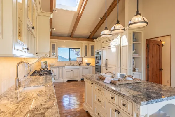 a large bathroom with a granite countertop double vanity sink a mirror and a shower