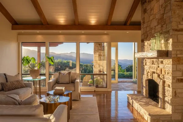 a living room with fireplace furniture and a fireplace