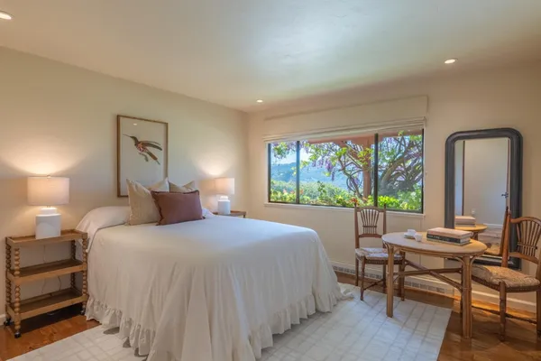 a bedroom with a bed and a large window