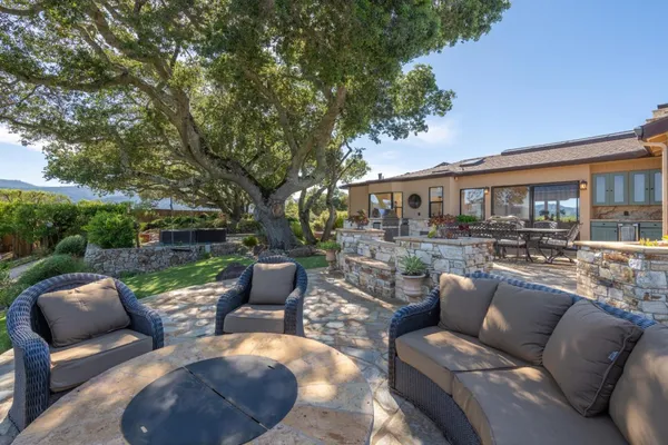 a view of a patio with couches chairs and a fire pit