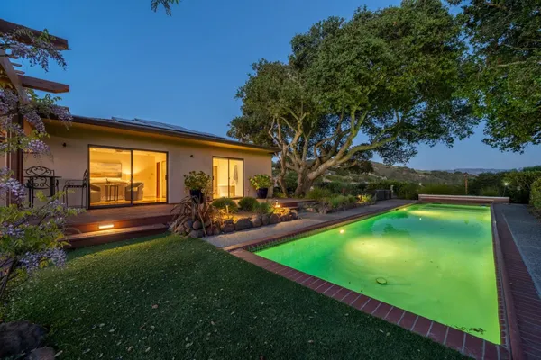 a view of a backyard with swimming pool