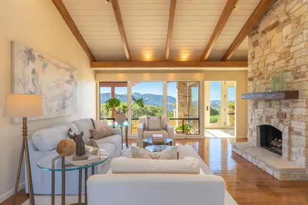 a living room with furniture and a fireplace