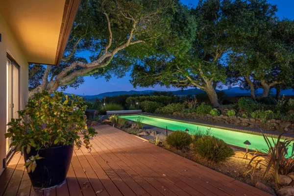 a view of a house with a yard and potted plants