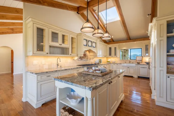 a kitchen with stainless steel appliances granite countertop a stove and a sink