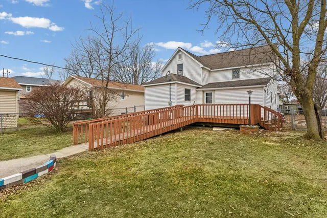 a view of a house with a yard covered in snow