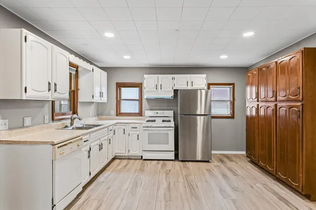a kitchen with stainless steel appliances granite countertop a refrigerator sink and cabinets