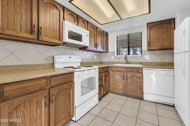 a kitchen with a stove sink and cabinets