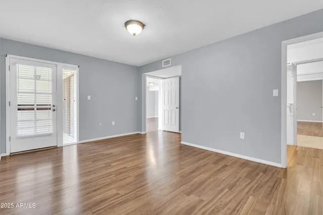 a view of a room with wooden floor