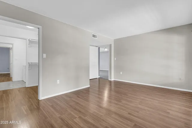 a bathroom with a granite countertop toilet sink and mirror