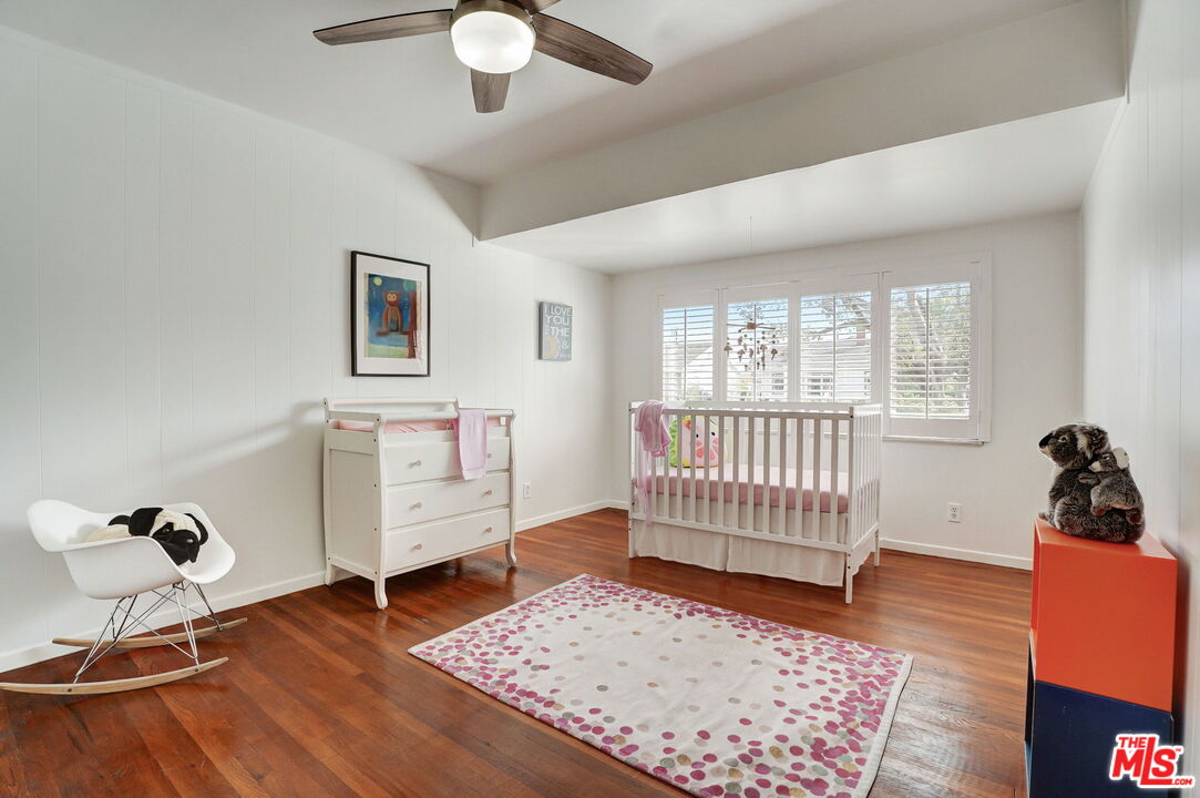 6215 West 77th Street Los Angeles, CA 90045 - Photo 11 of 23 a bedroom with a bed and wooden floor