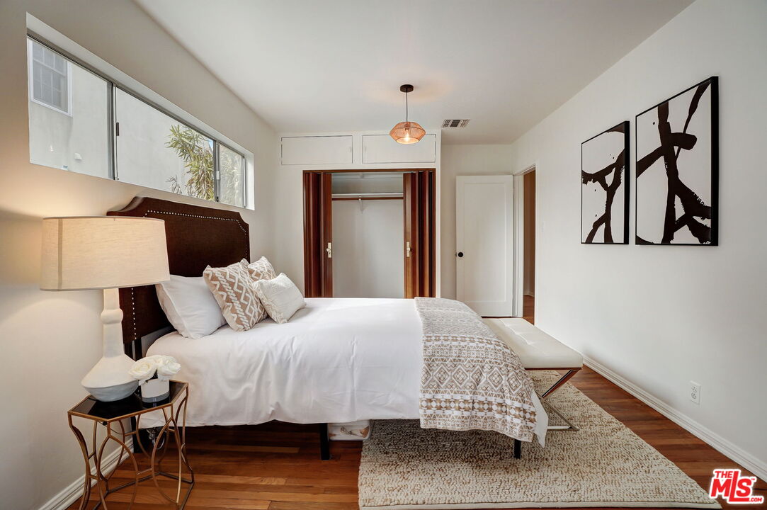6215 West 77th Street Los Angeles, CA 90045 - Photo 12 of 23 a bedroom with a bed and wooden floor