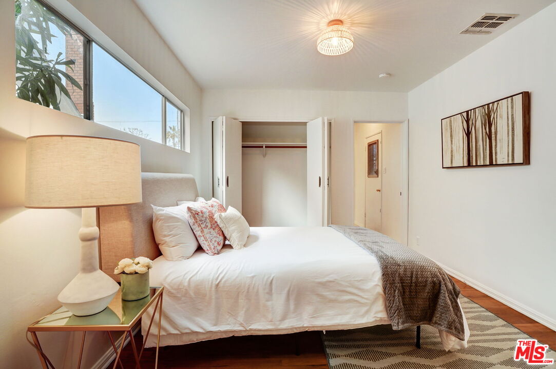 6215 West 77th Street Los Angeles, CA 90045 - Photo 14 of 23 a bedroom with a bed and wooden floor