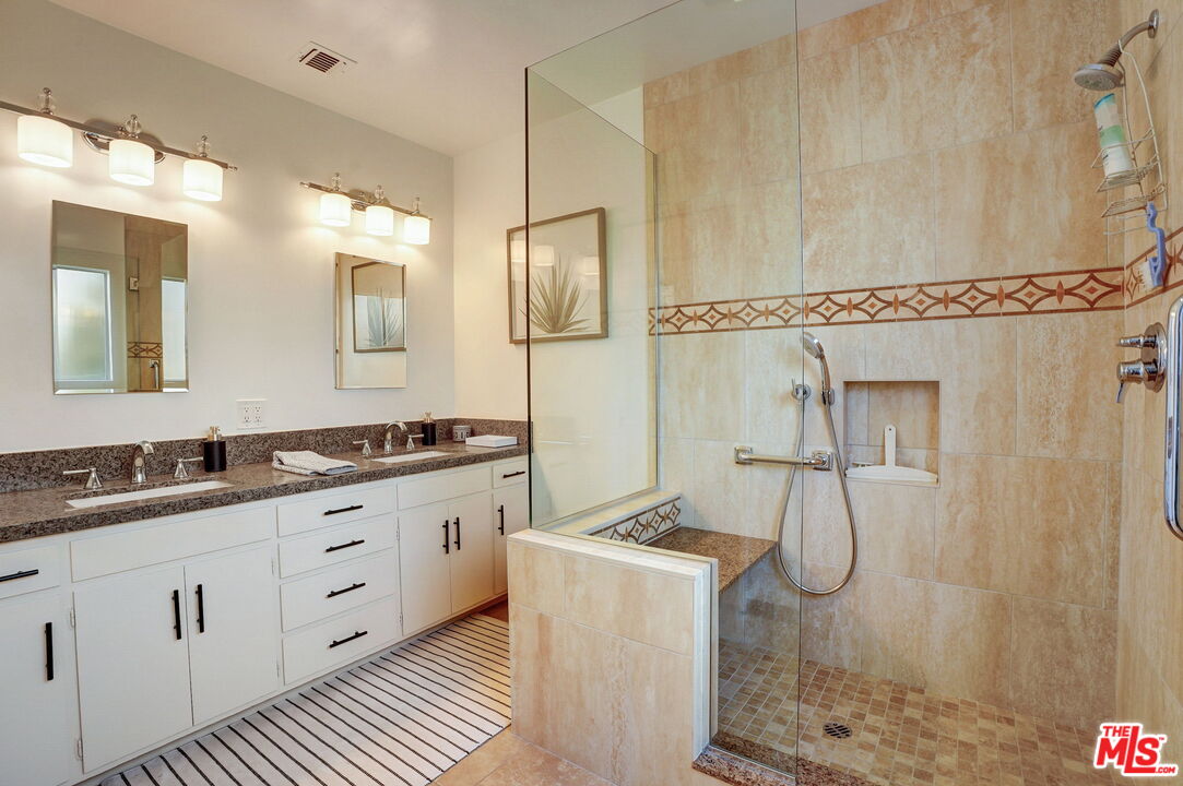 6215 West 77th Street Los Angeles, CA 90045 - Photo 15 of 23 a bathroom with a granite countertop sink a mirror and a shower