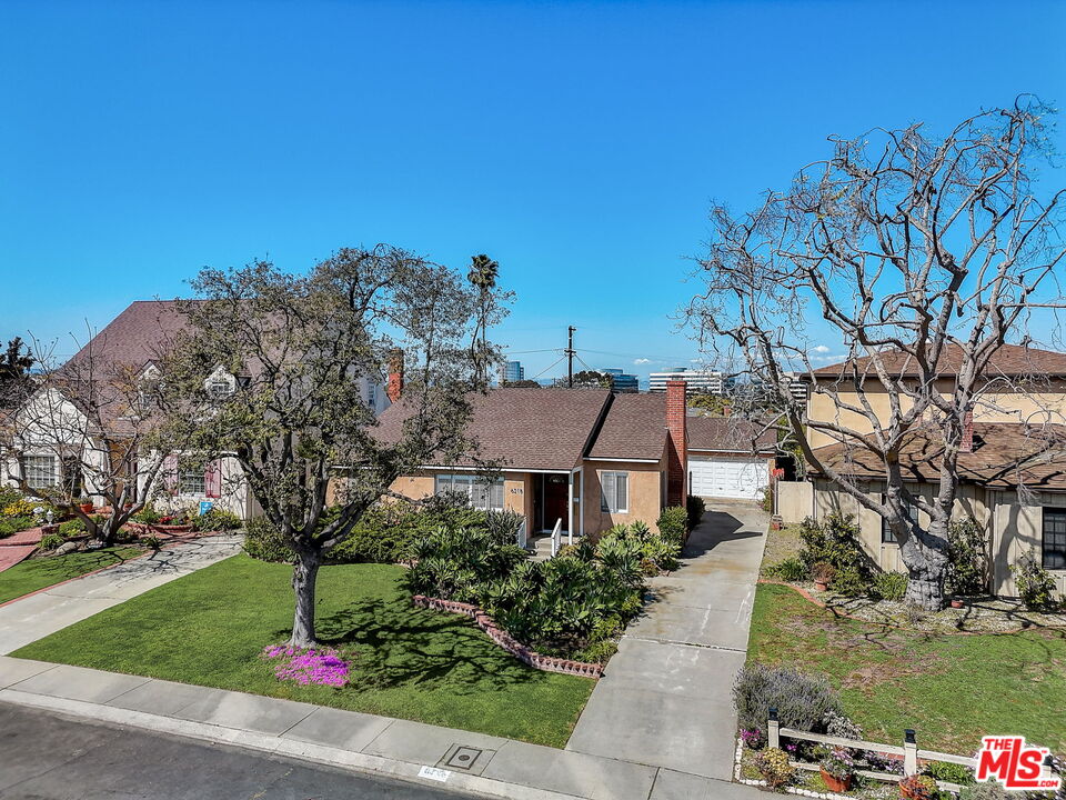 6215 West 77th Street Los Angeles, CA 90045 - Photo 20 of 23 a front view of a house with a yard and a large tree