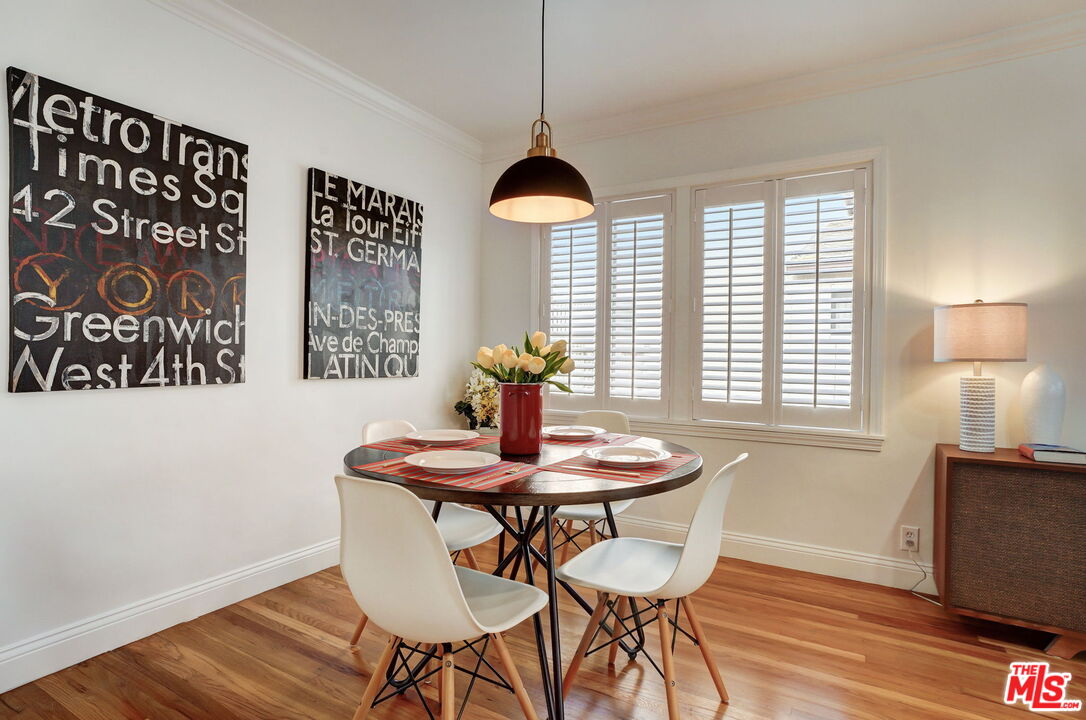 6215 West 77th Street Los Angeles, CA 90045 - Photo 7 of 23 a dining room with chandelier and wooden floor