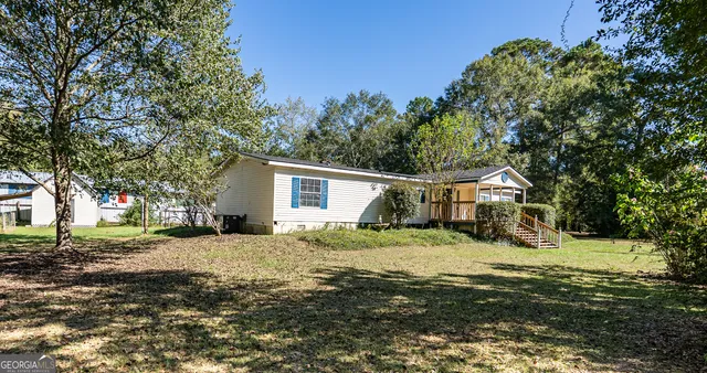 a view of a yard with a house and a tree