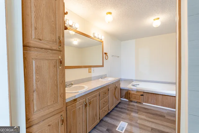 a bathroom with a double vanity sink a mirror and a