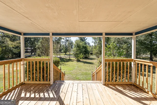 a view of a porch with wooden floor