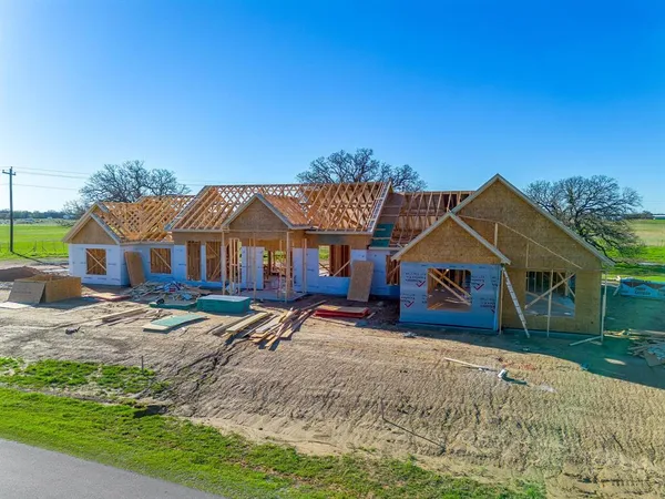 a roof deck with a table and chairs under an umbrella