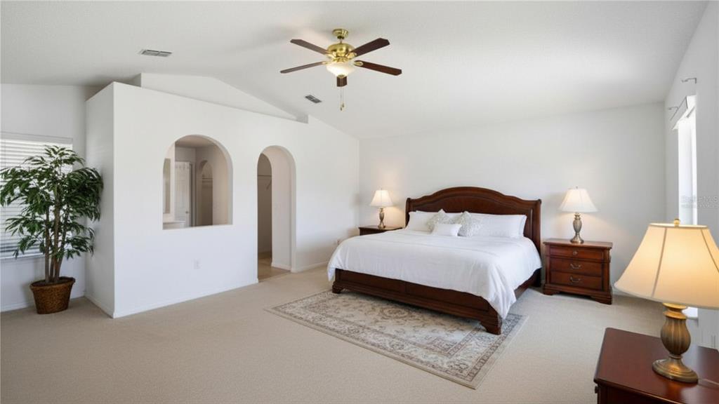 206 Taranto Way Kissimmee, FL 34758 - Photo 25 of 45 a bedroom with bed and a potted plant
