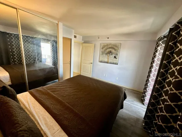 a bedroom with a bed and a mirror
