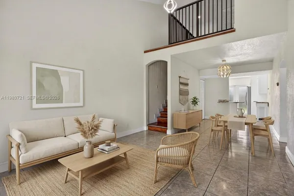 a living room with furniture a wooden floor and a chandelier