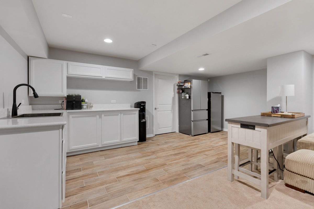 1430 Souders Avenue Elburn, IL 60119 - Photo 25 of 37 a kitchen with a sink cabinets and wooden floor