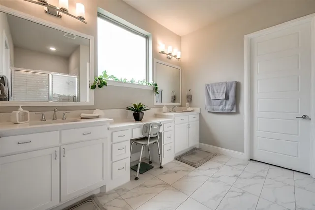 a spacious bathroom with a sink vanity and mirror