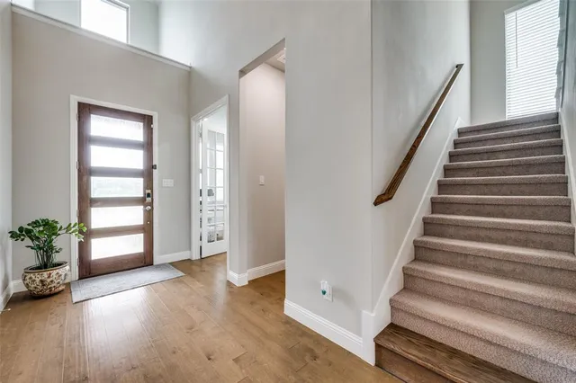 a view of entryway with wooden floor and stairs