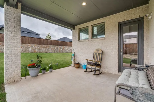 a backyard of a house with outdoor seating