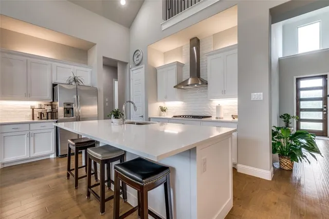 a kitchen with kitchen island a table and chairs in it