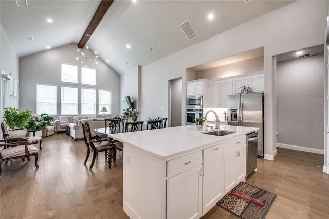 a large white kitchen with lots of table and chairs