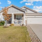a view of house with backyard and sitting area