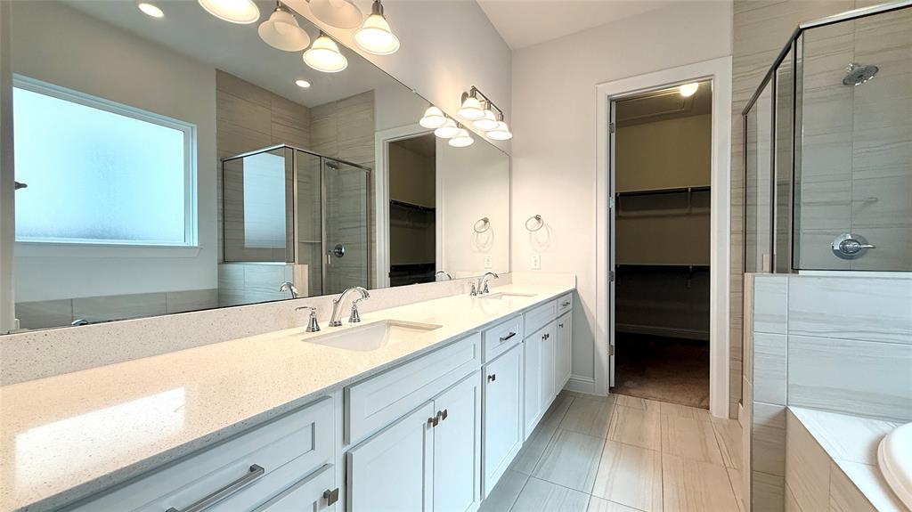 601 C-Bar Ranch Trail, Unit 27 Cedar Park, TX 78613 - Photo 22 of 29 Double vanity with quartz countertops, undermount sinks, and chrome fixtures